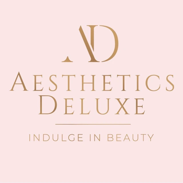 Aesthetics Deluxe Clinic logo — gold monogram on blush pink